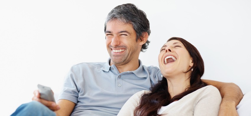 Happy couple watching funny movie